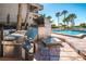 A stainless steel outdoor kitchen sits beside a pool with views of palm trees at 1660 Gulf Blvd # Ph-7, Clearwater Beach, FL 33767