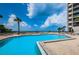 Large, sparkling swimming pool with poolside seating and ocean views, perfect for relaxation and enjoying the Florida sunshine at 1660 Gulf Blvd # Ph-7, Clearwater Beach, FL 33767