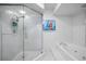 Bathroom featuring a walk-in shower and a tub at 1660 Gulf Blvd # Ph-7, Clearwater Beach, FL 33767
