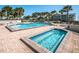These two swimming pools and a hot tub are surrounded by brick pavers and palm trees at 1660 Gulf Blvd # Ph-7, Clearwater Beach, FL 33767