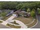 Aerial view of a charming home with a large driveway and mature trees at 1686 Spottswood Cir, Palm Harbor, FL 34683
