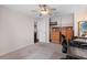 Bedroom with a view into the dining room/kitchen, with neutral carpet and a ceiling fan at 1686 Spottswood Cir, Palm Harbor, FL 34683