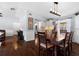 Open dining area with hardwood floors, a wooden table, and views into the adjacent living spaces at 1686 Spottswood Cir, Palm Harbor, FL 34683