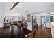 Dining room with wood table and chairs, opening to kitchen and living area with hardwood floors throughout at 1686 Spottswood Cir, Palm Harbor, FL 34683
