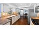Well-lit kitchen featuring white cabinets, a stainless steel refrigerator, and hardwood floors, leading to the dining area at 1686 Spottswood Cir, Palm Harbor, FL 34683