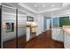 Modern kitchen with stainless steel appliances, white cabinetry, and hardwood floors, leading to adjacent rooms at 1686 Spottswood Cir, Palm Harbor, FL 34683
