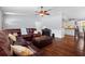 Open living area features hardwood floors and a view into the modern kitchen at 1686 Spottswood Cir, Palm Harbor, FL 34683