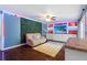 Stylish living room with an eye-catching wall garden and custom shelving with neon accents at 1686 Spottswood Cir, Palm Harbor, FL 34683