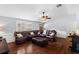 Comfortable living room with hardwood floors, a ceiling fan, and an oversized leather sofa at 1686 Spottswood Cir, Palm Harbor, FL 34683