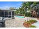 Outdoor living at its finest with a screened lanai, pool, patio, playground and tropical landscaping at 1686 Spottswood Cir, Palm Harbor, FL 34683