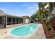 Relax in the screened lanai overlooking the beautiful pool and meticulously landscaped backyard at 1686 Spottswood Cir, Palm Harbor, FL 34683