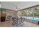 Covered outdoor dining area overlooks the pool area at 1686 Spottswood Cir, Palm Harbor, FL 34683
