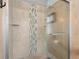 Walk-in shower features tiled surround and glass doors at 1686 Spottswood Cir, Palm Harbor, FL 34683