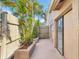 Enclosed backyard patio with tropical landscaping, a privacy fence, and sliding door access to the home at 170 Foxfire Ln, Oldsmar, FL 34677