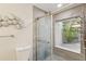 Bright bathroom featuring a glass-enclosed shower and decorative wall art, offering a modern aesthetic at 170 Foxfire Ln, Oldsmar, FL 34677