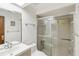 Tiled bathroom with glass-enclosed shower, sink, and modern fixtures at 170 Foxfire Ln, Oldsmar, FL 34677