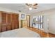 Bedroom with hardwood floors, closet, dresser, and access to outdoor patio at 170 Foxfire Ln, Oldsmar, FL 34677