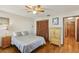 Cozy bedroom with hardwood floors, ceiling fan, closet, and side table at 170 Foxfire Ln, Oldsmar, FL 34677