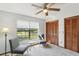 Sun-filled bedroom with large window, ceiling fan, and carpeted floors at 170 Foxfire Ln, Oldsmar, FL 34677