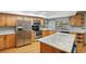 Bright kitchen features stainless steel appliances, light wood cabinetry and a marble top island at 170 Foxfire Ln, Oldsmar, FL 34677