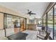 Screened-in lanai featuring an outdoor bar with views of the pool and surrounding landscaped yard at 170 Foxfire Ln, Oldsmar, FL 34677