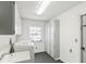 Well lit Laundry room with new washer and dryer, cabinet storage and sink at 170 Foxfire Ln, Oldsmar, FL 34677