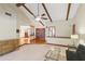 Spacious living room with neutral tones, wood beams, and an open floor plan to adjacent living spaces at 170 Foxfire Ln, Oldsmar, FL 34677