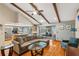 Open-concept living room with exposed wood beams, hardwood floors, and a view of the backyard pool at 170 Foxfire Ln, Oldsmar, FL 34677