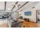 Bright living room with wood beams, hardwood floors, backyard views, and comfortable seating at 170 Foxfire Ln, Oldsmar, FL 34677