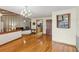 Open-concept living area with hardwood floors, staircase, and view of kitchen at 170 Foxfire Ln, Oldsmar, FL 34677