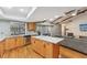 Open concept living room and kitchen with hardwood floors, exposed beams, and stainless steel appliances at 170 Foxfire Ln, Oldsmar, FL 34677