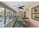 A covered outdoor kitchen features granite countertops, a sink, a grill, and stainless steel appliances with ceiling fans at 170 Foxfire Ln, Oldsmar, FL 34677
