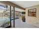 A covered outdoor kitchen features granite countertops, a mini fridge and a serving area leading to the screened in pool at 170 Foxfire Ln, Oldsmar, FL 34677