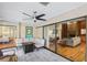 The covered patio includes a ceiling fan, comfortable seating, and sliding glass doors leading to the interior living spaces at 170 Foxfire Ln, Oldsmar, FL 34677