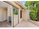 Enclosed patio with slider access to interior, tile flooring and tropical landscaping offer tranquil outdoor retreat at 170 Foxfire Ln, Oldsmar, FL 34677