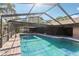 Refreshing screened-in pool with brick pavers offers a private oasis for relaxation and recreation at 170 Foxfire Ln, Oldsmar, FL 34677
