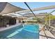 The screened-in pool and patio area offer a refreshing outdoor retreat with a comfortable seating area for relaxation at 170 Foxfire Ln, Oldsmar, FL 34677