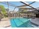 The screened-in pool and patio are surrounded by lush landscaping and fencing, offering privacy and relaxation at 170 Foxfire Ln, Oldsmar, FL 34677