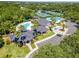 Aerial view of a clubhouse, pool, tennis courts, lush landscaping, and parking at 18002 Forest Retreat Ln, Tampa, FL 33647