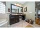 Bathroom vanity with granite counters and decorative mirror at 18002 Forest Retreat Ln, Tampa, FL 33647