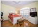Bright bedroom with hardwood floors, white furniture, and a large window with shutters at 18002 Forest Retreat Ln, Tampa, FL 33647