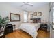 Bedroom with hardwood floors, neutral walls, and a cozy comforter at 18002 Forest Retreat Ln, Tampa, FL 33647