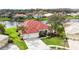 Beautiful home with a red tile roof, lush landscaping, and a three-car garage on a well-maintained green lawn at 18002 Forest Retreat Ln, Tampa, FL 33647