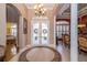 Elegant foyer with tile flooring, columns, and a view into the dining room at 18002 Forest Retreat Ln, Tampa, FL 33647