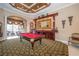 Spacious game room featuring a pool table, bar area, and decorative ceiling at 18002 Forest Retreat Ln, Tampa, FL 33647