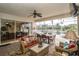 Relaxing outdoor lanai featuring a dining area, lounge seating, and scenic waterfront views for enjoyable entertaining at 18002 Forest Retreat Ln, Tampa, FL 33647