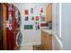 Functional laundry room with modern washer/dryer units, cabinet storage, and whimsical decor for added charm at 18002 Forest Retreat Ln, Tampa, FL 33647