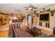 Open-concept living room featuring a glimpse of the kitchen, media center, and comfortable seating at 18002 Forest Retreat Ln, Tampa, FL 33647