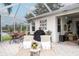 Secluded outdoor patio with lounge chairs, dining area, and serene lake views for tranquil relaxation and entertaining at 18002 Forest Retreat Ln, Tampa, FL 33647