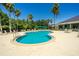 Resort style pool with surrounding lounge chairs, lush landscaping and clubhouse at 18002 Forest Retreat Ln, Tampa, FL 33647